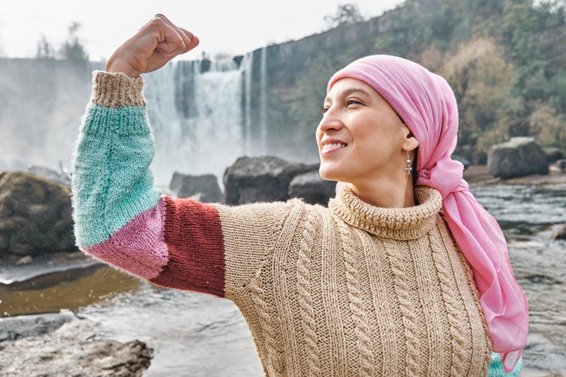 Latina woman showing arms for strength