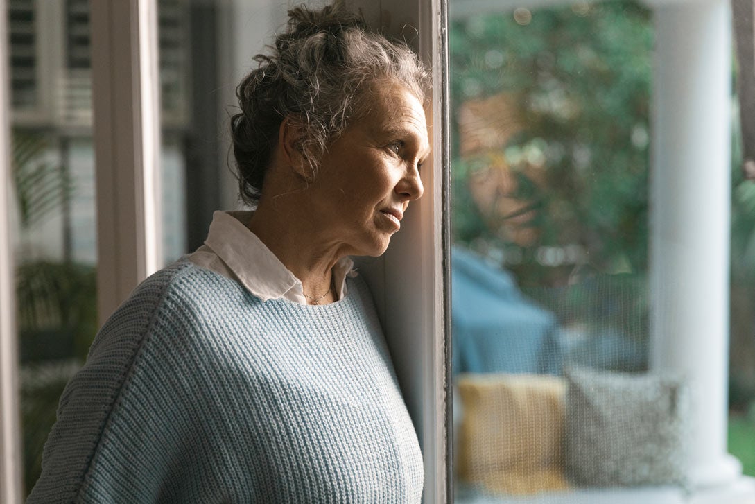 Woman staring out window