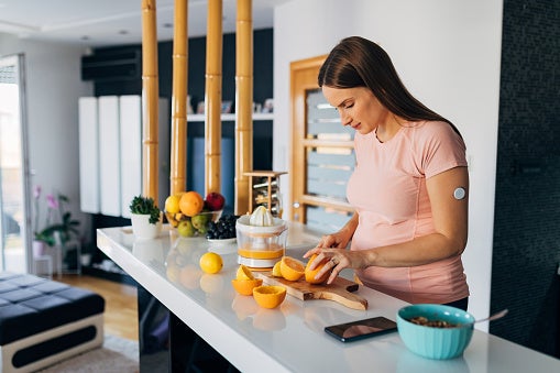 Woman cutting oranges while pregnant