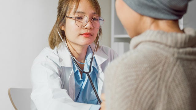 Doctor listening to patient's lungs