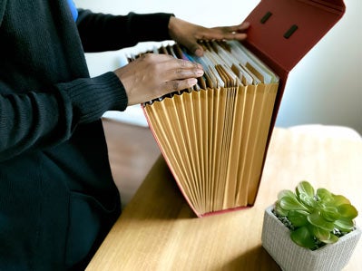 Hand going through files in folder