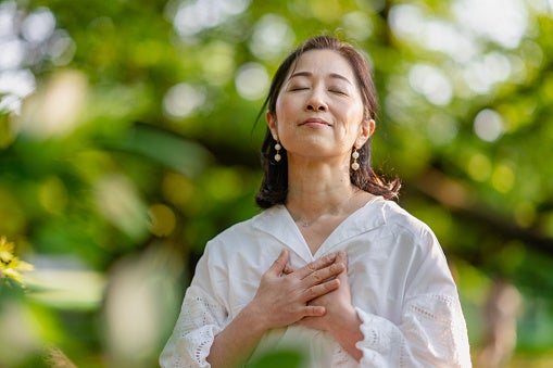 Mature women breathing deeply outside