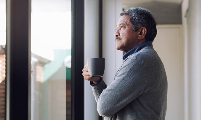 Man looking out window