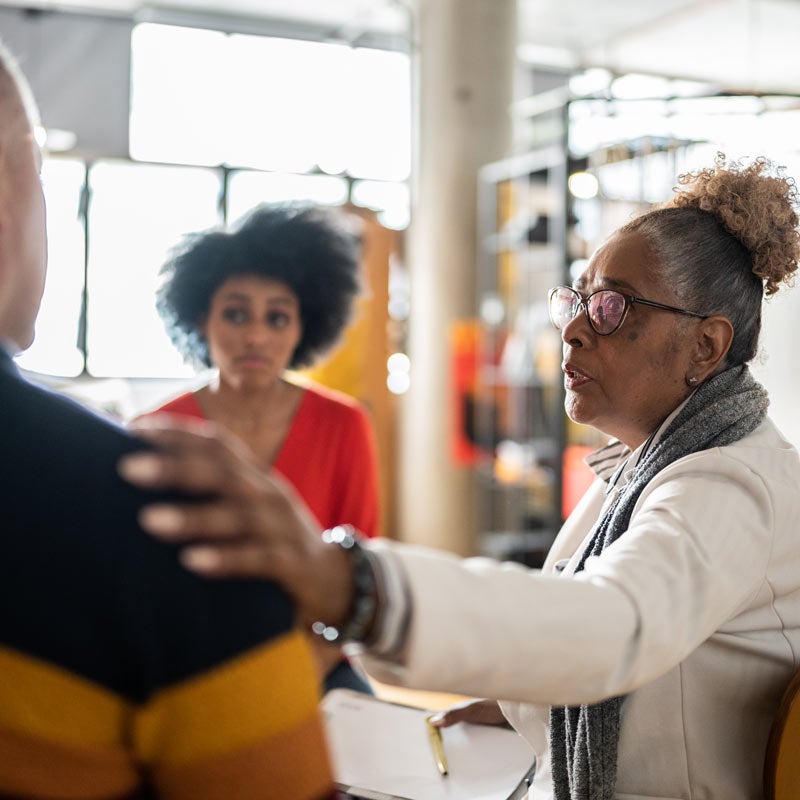 Woman supporting man at a group meeting