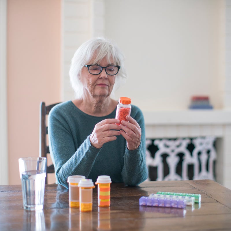 Mature woman reading medicine label